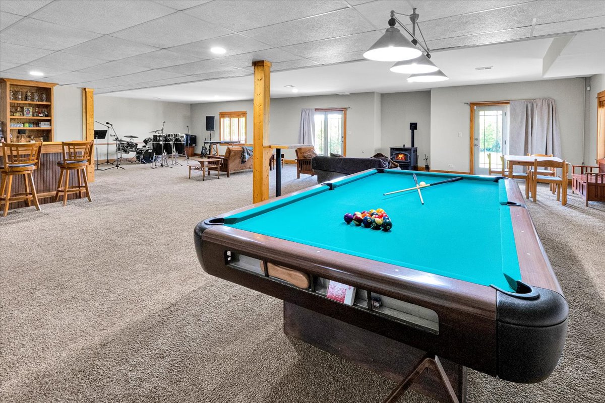 Lower-level billiards area with custom bar and seating